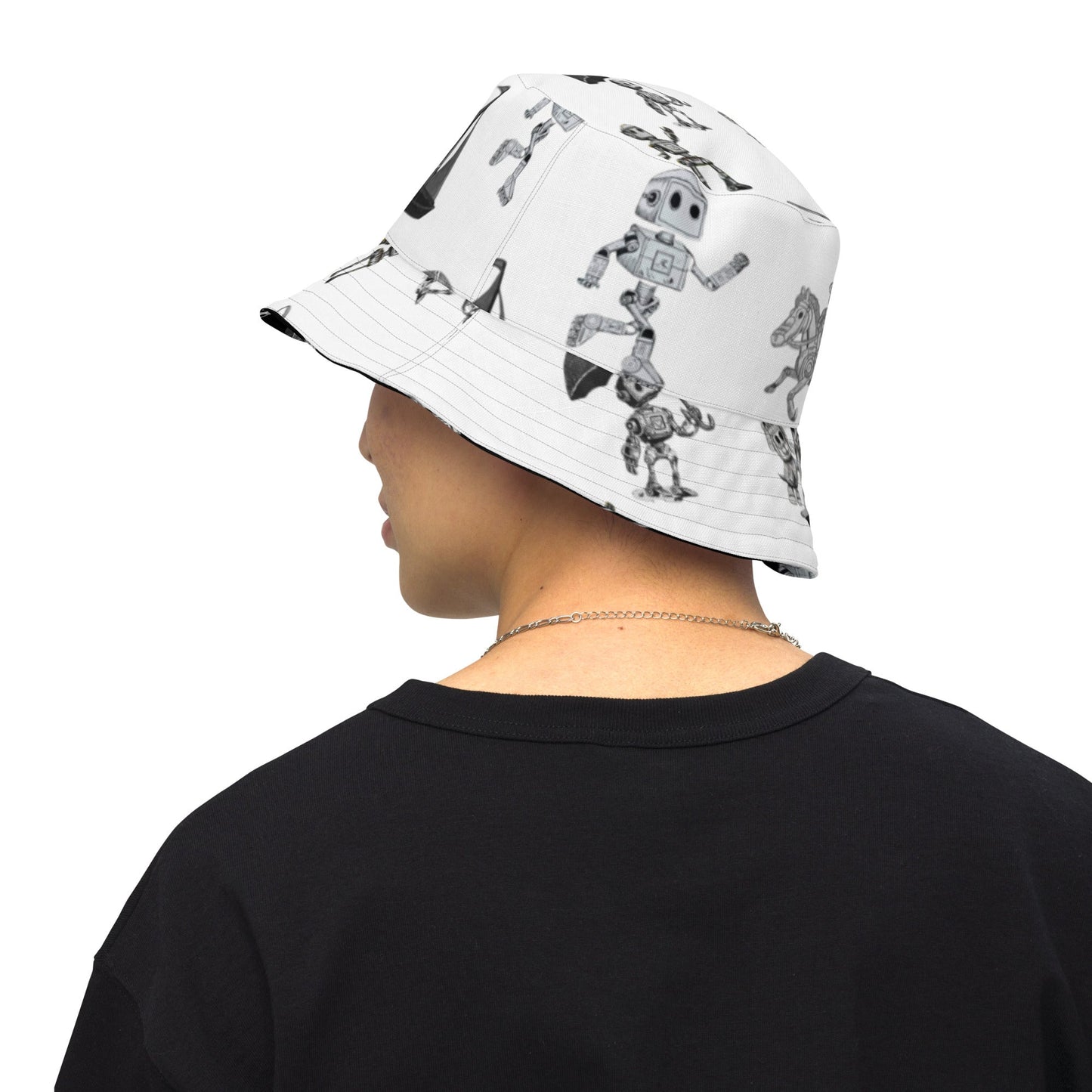 Reversible moisture-wicking fabric bucket hat in black and white with robot design.