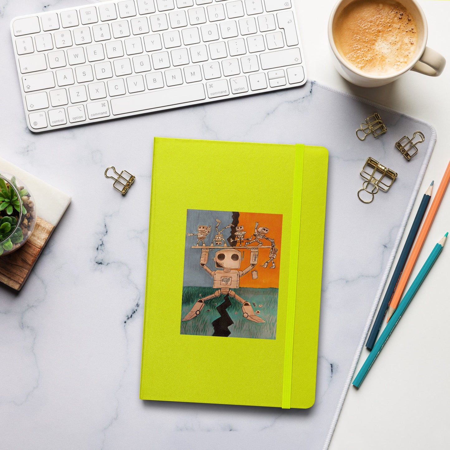 Hardcover bound journal with elastic closure, ribbon marker, and expandable pocket on a desk.