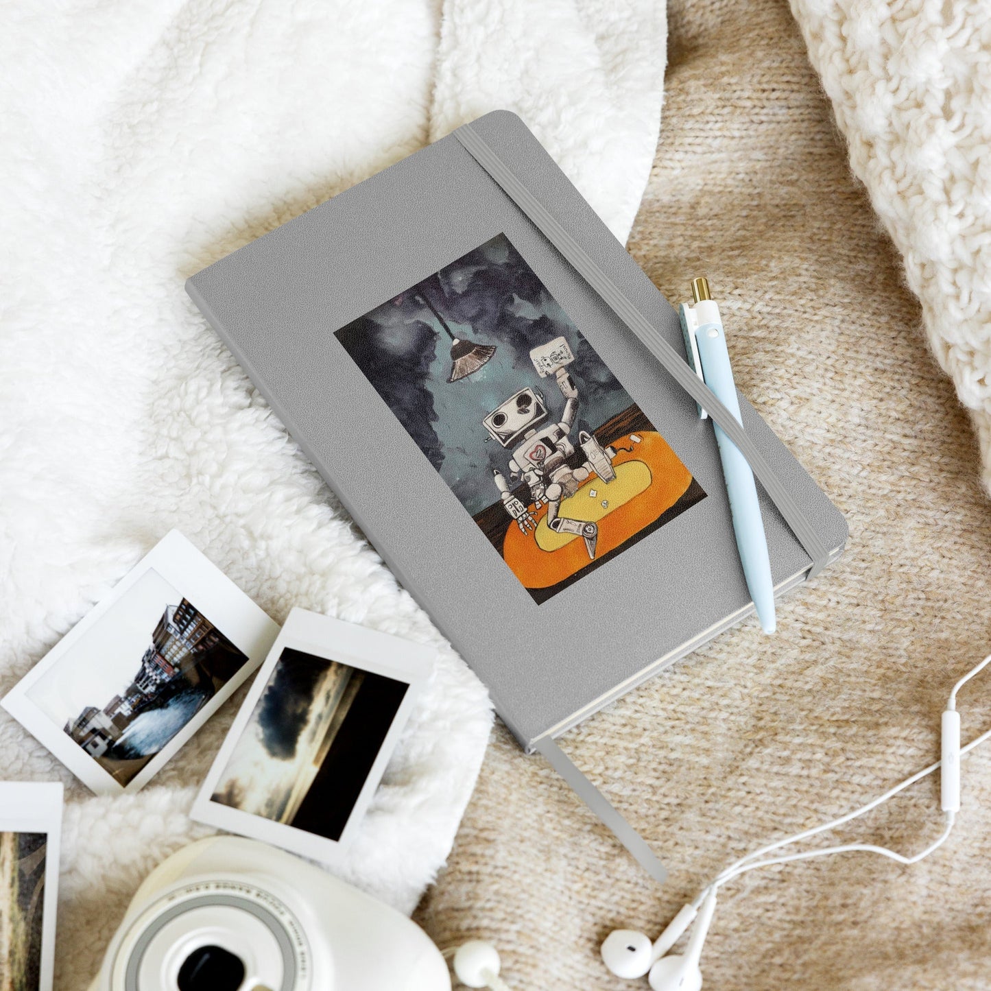 Hardcover notebook with elastic closure and ribbon marker on soft fabric.